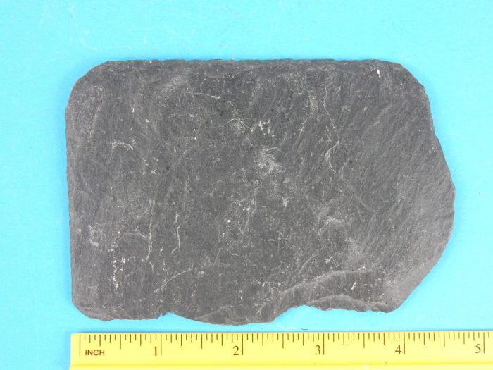 A four-inch-long flat slab of Black Slate