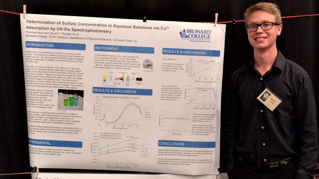 Thomas Kent standing in front of his research poster